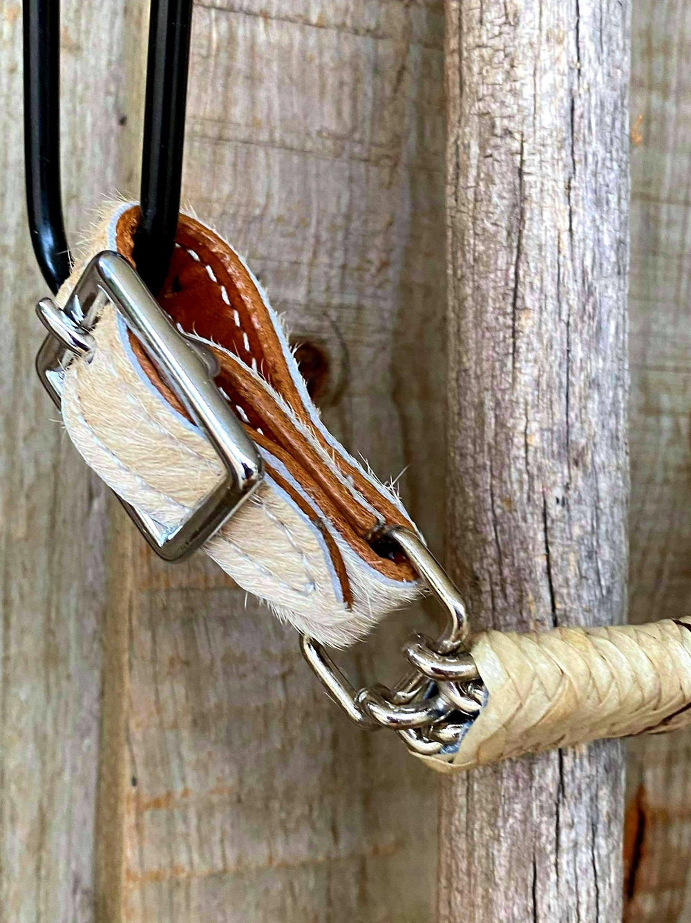 Curb Strap - Curb strap with hair on cowhide ends with rawhide braided covered chain. Adjusts 7" to 9".